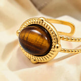 Bague cabochon ovale en Œil de tigre OVALIA®, acier doré