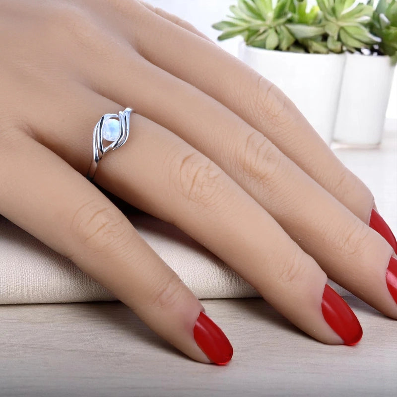 Bague en Pierre de Lune (Rayon Nacré) portée — pierre ronde 5 mm, monture argent rhodié minimaliste et moderne