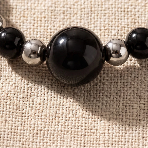 Gros plan sur les perles d'onyx de la bague élastique ALÉNA®