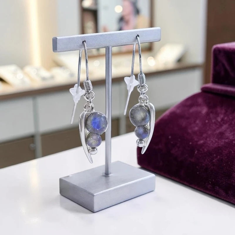 Gros plan sur la pierre et la monture des boucles d'oreilles Menkalinan en labradorite