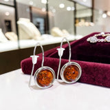 Boucles d'Oreilles Ambre Ronde Pendantes en Argent Rhodié (Spica)