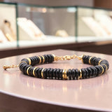 Bracelet perles plates en Onyx noir DISQUE®, acier doré