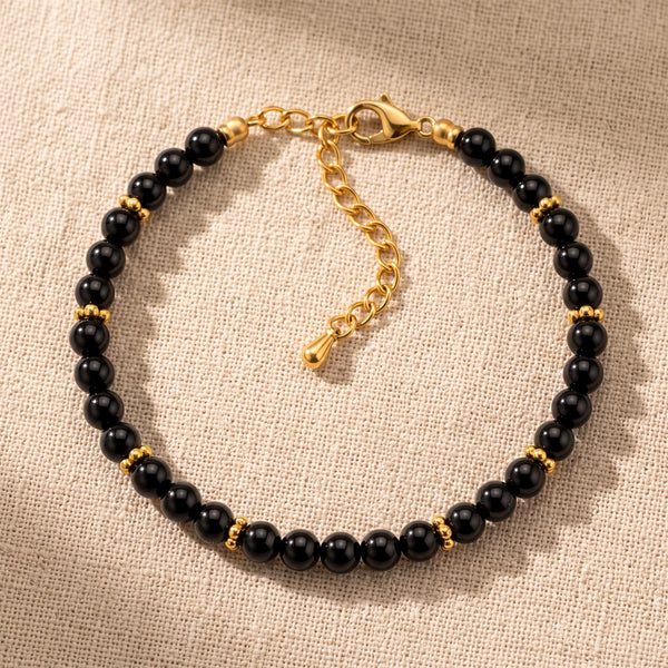 Bracelet pierre naturelle noire ORÉLIA® en perles d'onyx noir de 4 mm, rondelles fleurs dorées