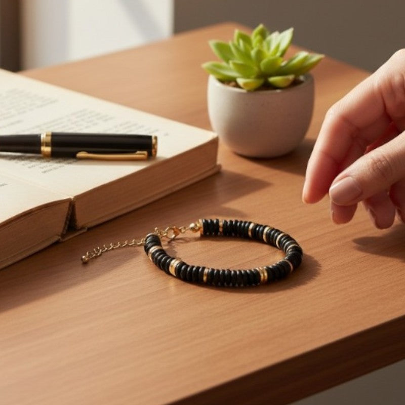 Gros plan des perles plates 6 mm en onyx noir du bracelet DISQUE®, d'un noir profond et brillant
