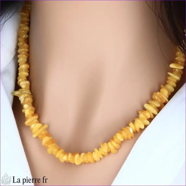 Collier en Ambre baroque jaune porté au cou, mettant en valeur sa couleur solaire et son style élégant.