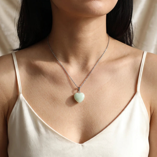 Collier pendentif cœur en jade vert naturel porté par une femme, chaîne argentée