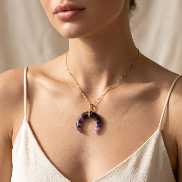 Collier pendentif croissant de lune en améthyste violette porté par une femme