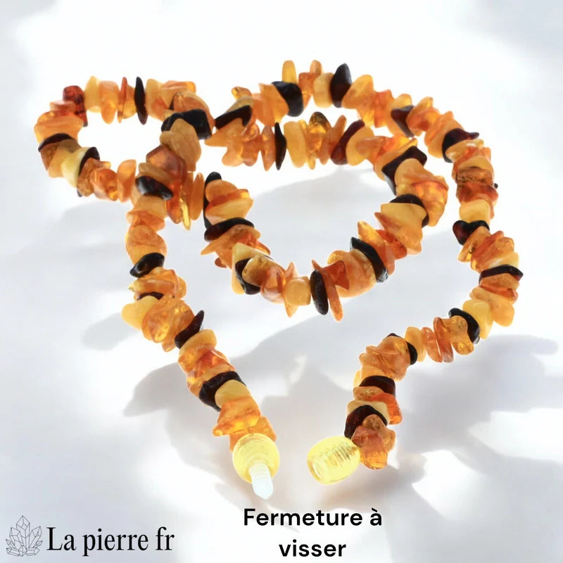 Gros plan sur les perles baroques d'un collier en Ambre véritable, montrant la diversité des formes et des couleurs cognac, jaune et miel.