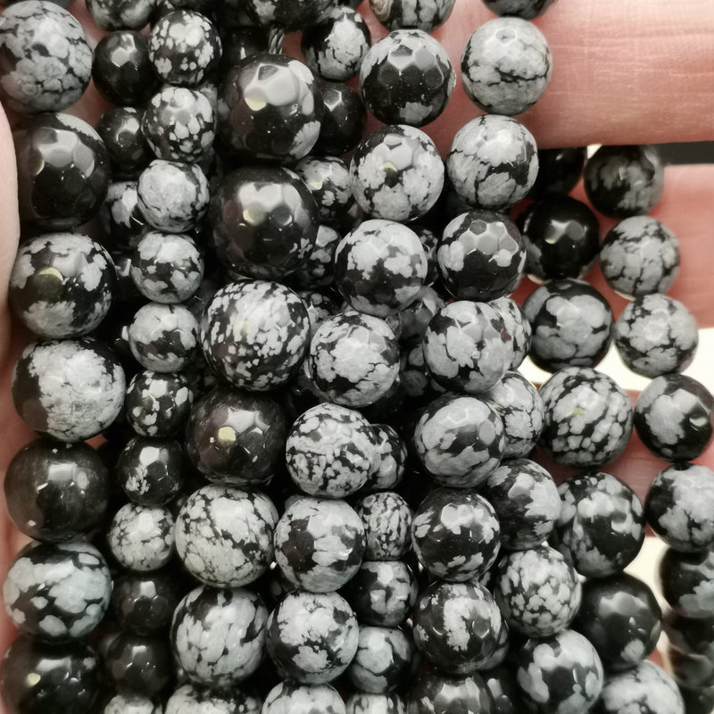 Détail des flocons blancs d'une perle d'obsidienne neige