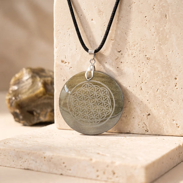Pendentif fleur de vie gravée sur un disque d'obsidienne dorée naturelle