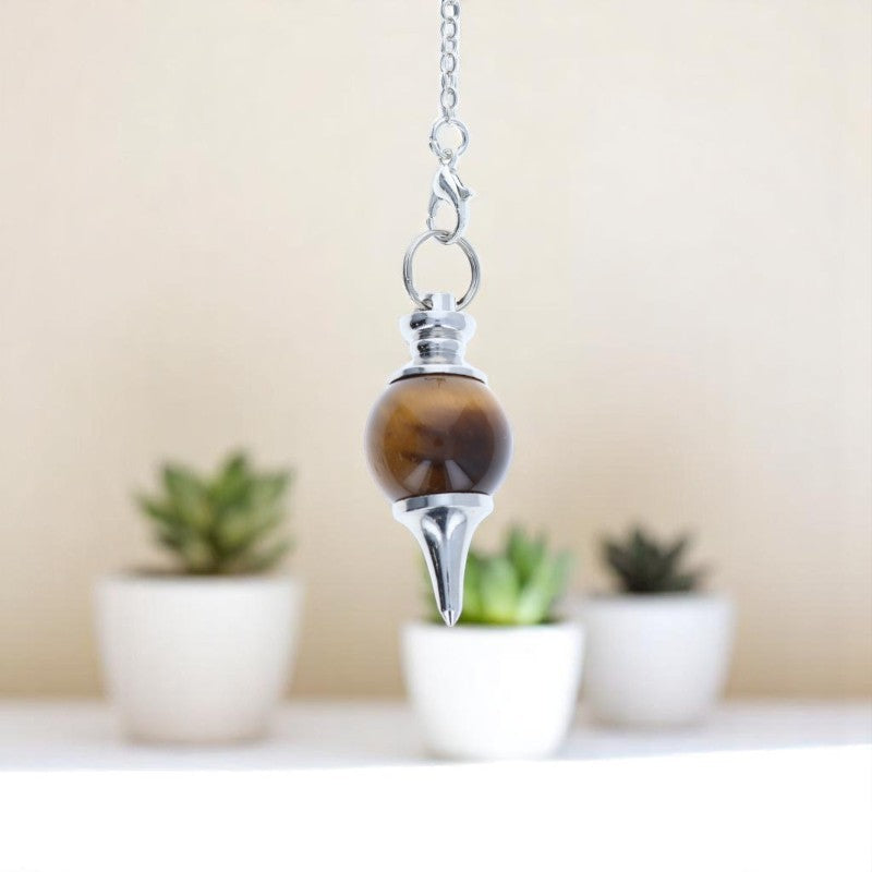 Pendule divinatoire Séphoroton (Oeil de Tigre) forme sphère pointe sur fond texturé