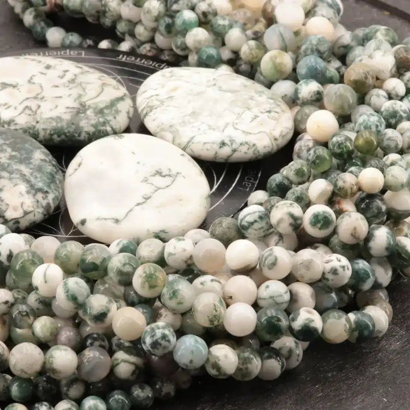 Gros plan sur des perles d'Agate Arbre, pierre naturelle pour bracelet et collier de lithothérapie
