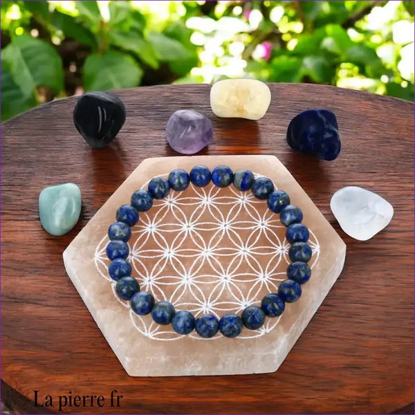 Plaque de rechargement en sélénite orange avec Fleur de Vie. Dynamise, purifie et recharge vos pierres et bijoux.
