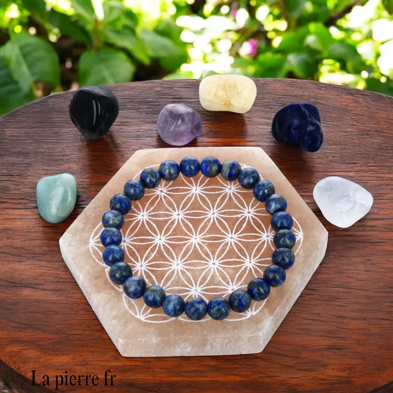 Plaque de rechargement en sélénite orange avec Fleur de Vie. Dynamise, purifie et recharge vos pierres et bijoux.