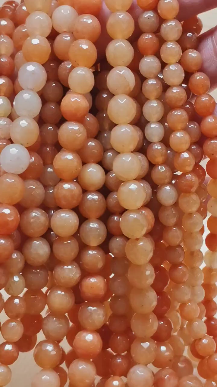 Vidéo des perles d'aventurine orange facettées sur fil de 36 cm